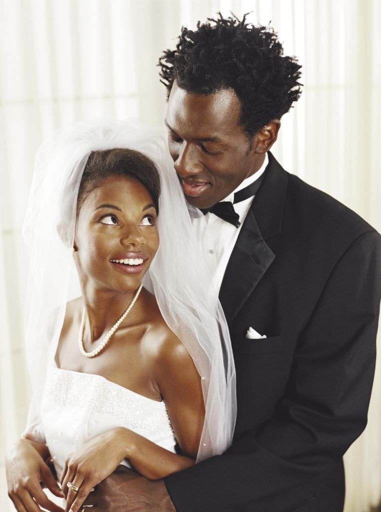Bride and groom smiling at each other