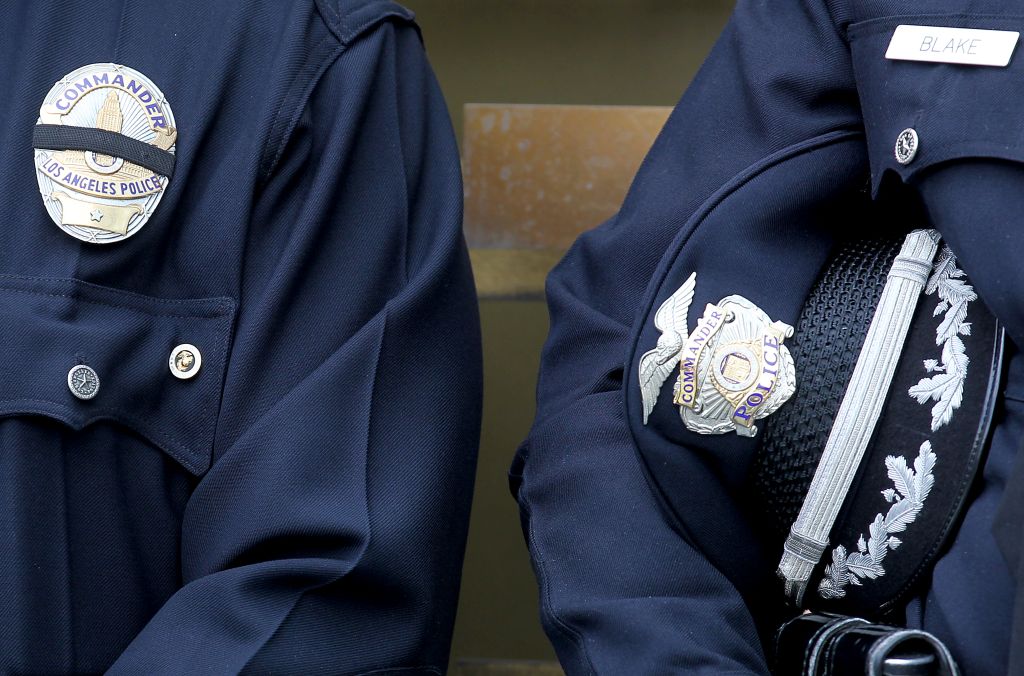 LOS ANGELES, CALIF. - DEC. 24, 2014. Police officers take a moment to pray Wednesday, Dec. 24, 2014
