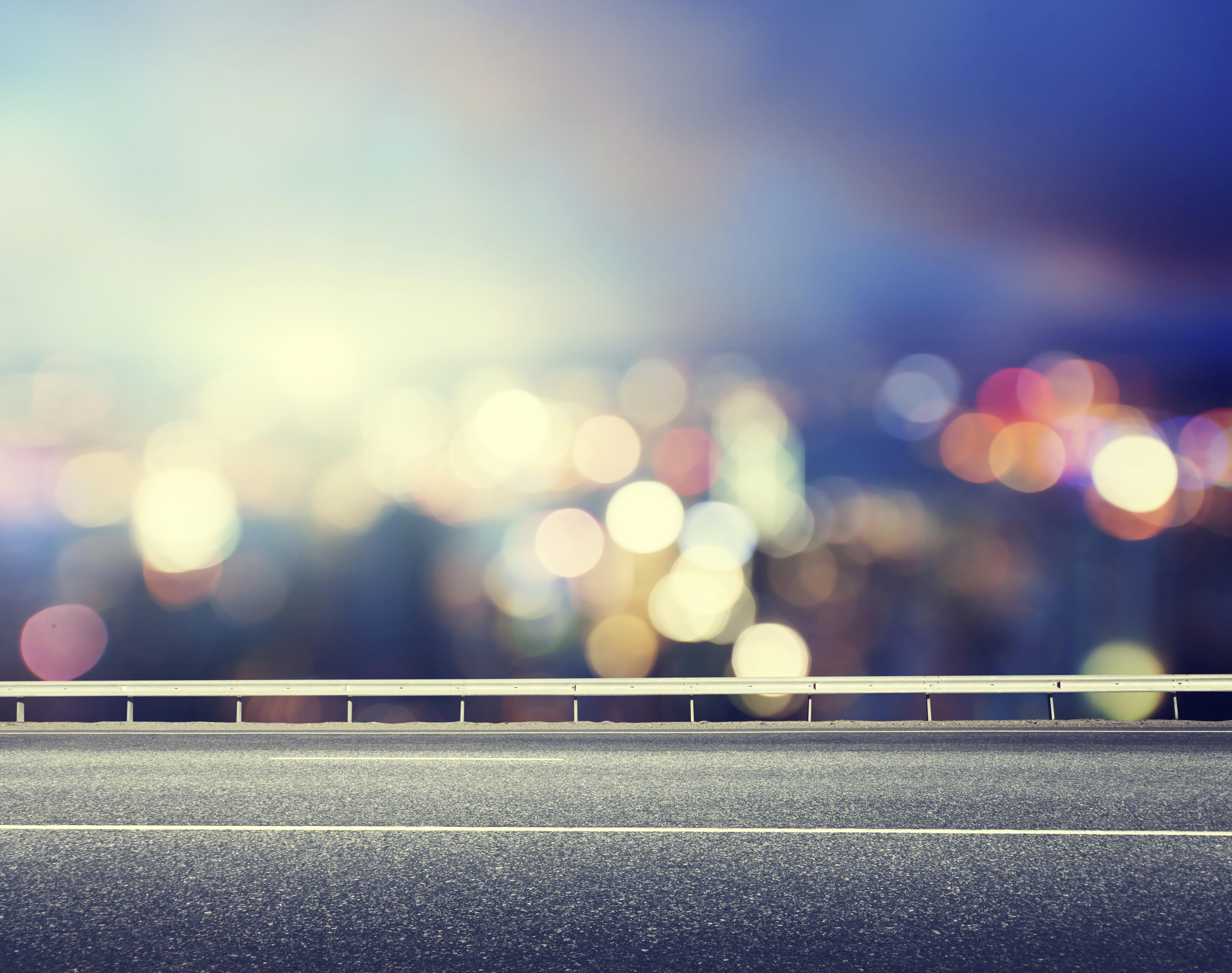 Asphalt road and blurred modern city