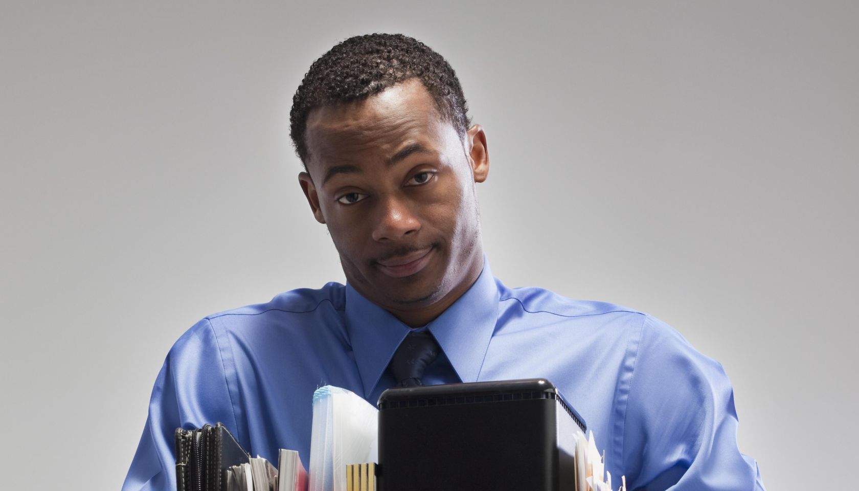 Businessman holding a box of office supplies