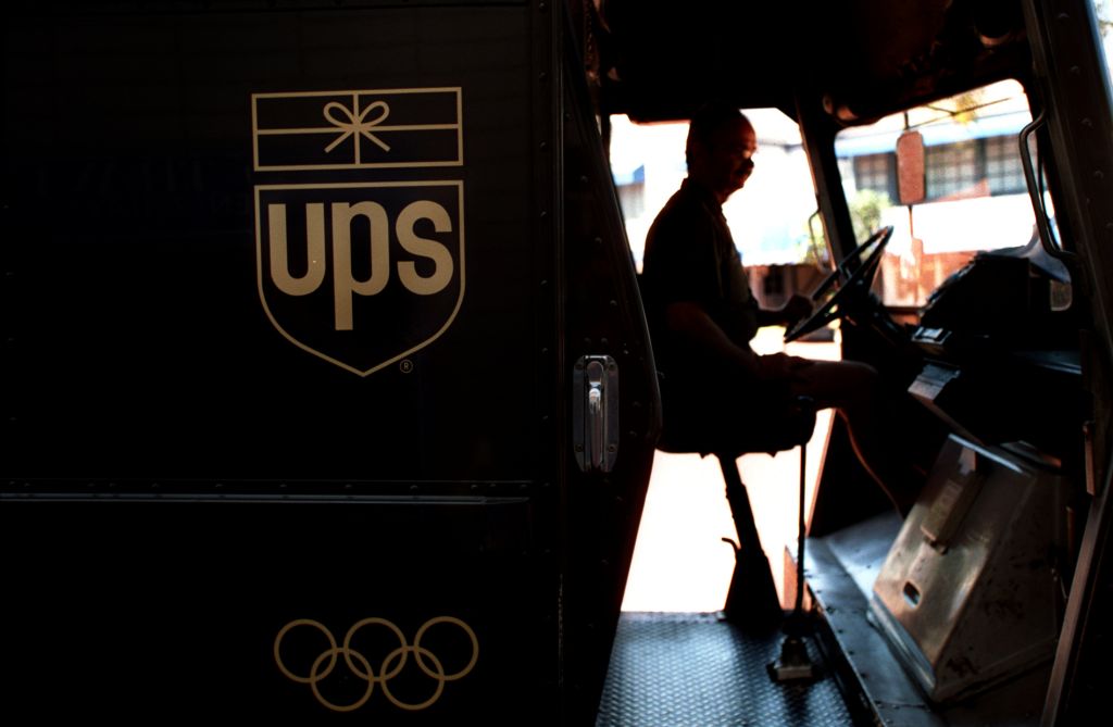 FI.UPS.silhouette.0801.AAGUnited Parcel Service deliveryman Ken Malek starts up his van to continu