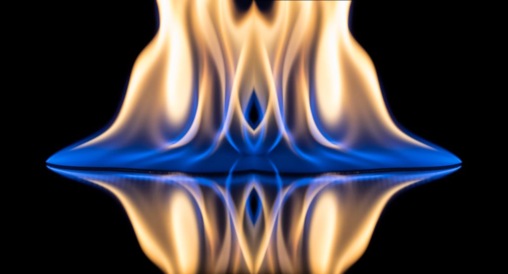 Flames of orange and blue with reflections on a black background color