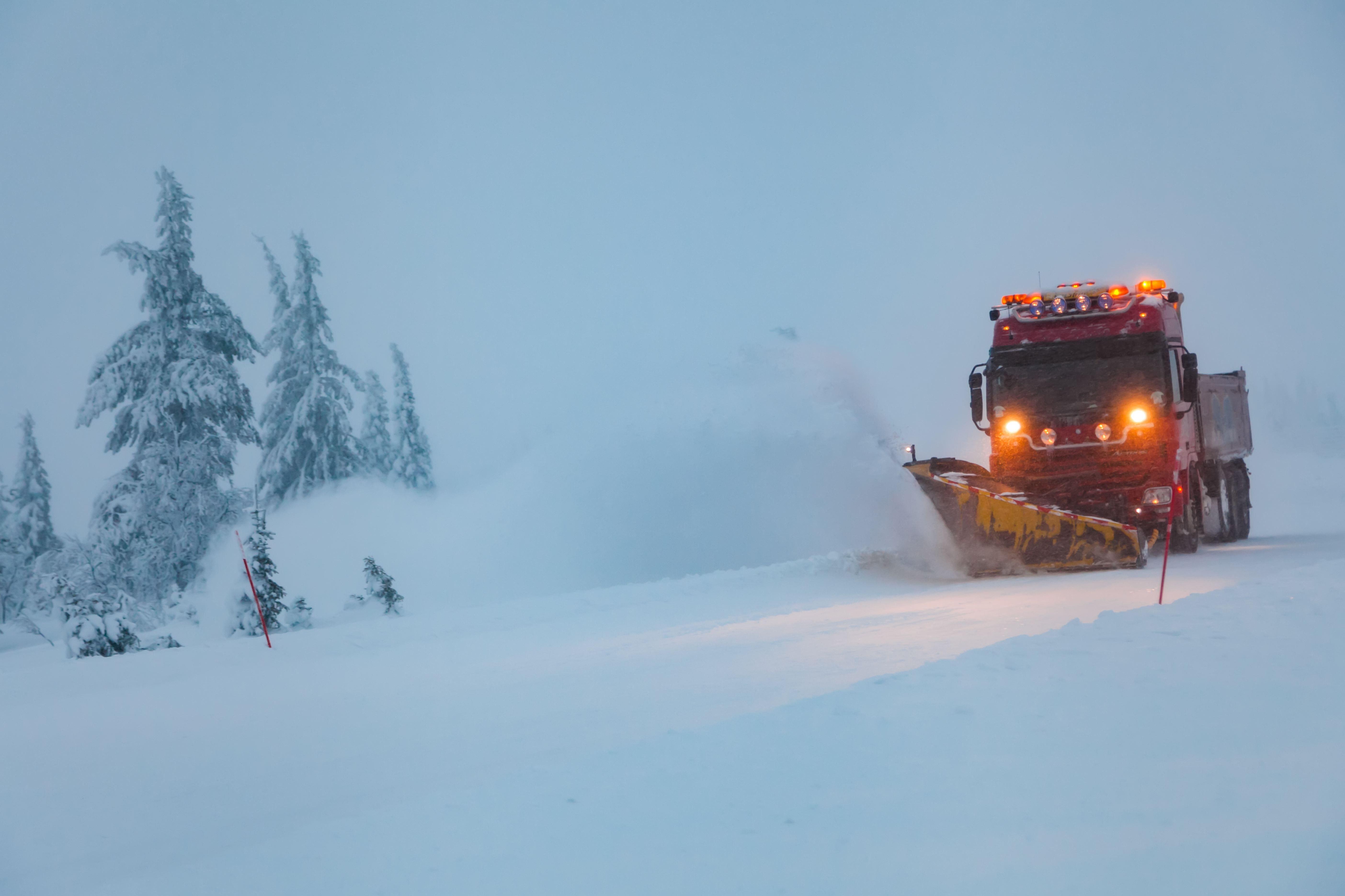 Snowblower grader clears snow covered country road