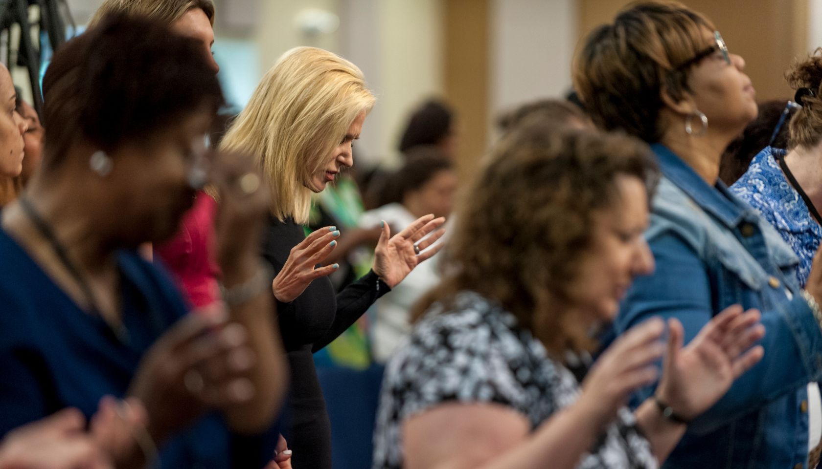 Visiting Pastor Paula White, a Pentecostal Christian televangelist, prays before giving a sermon to the congregation at Hope Christian Church...