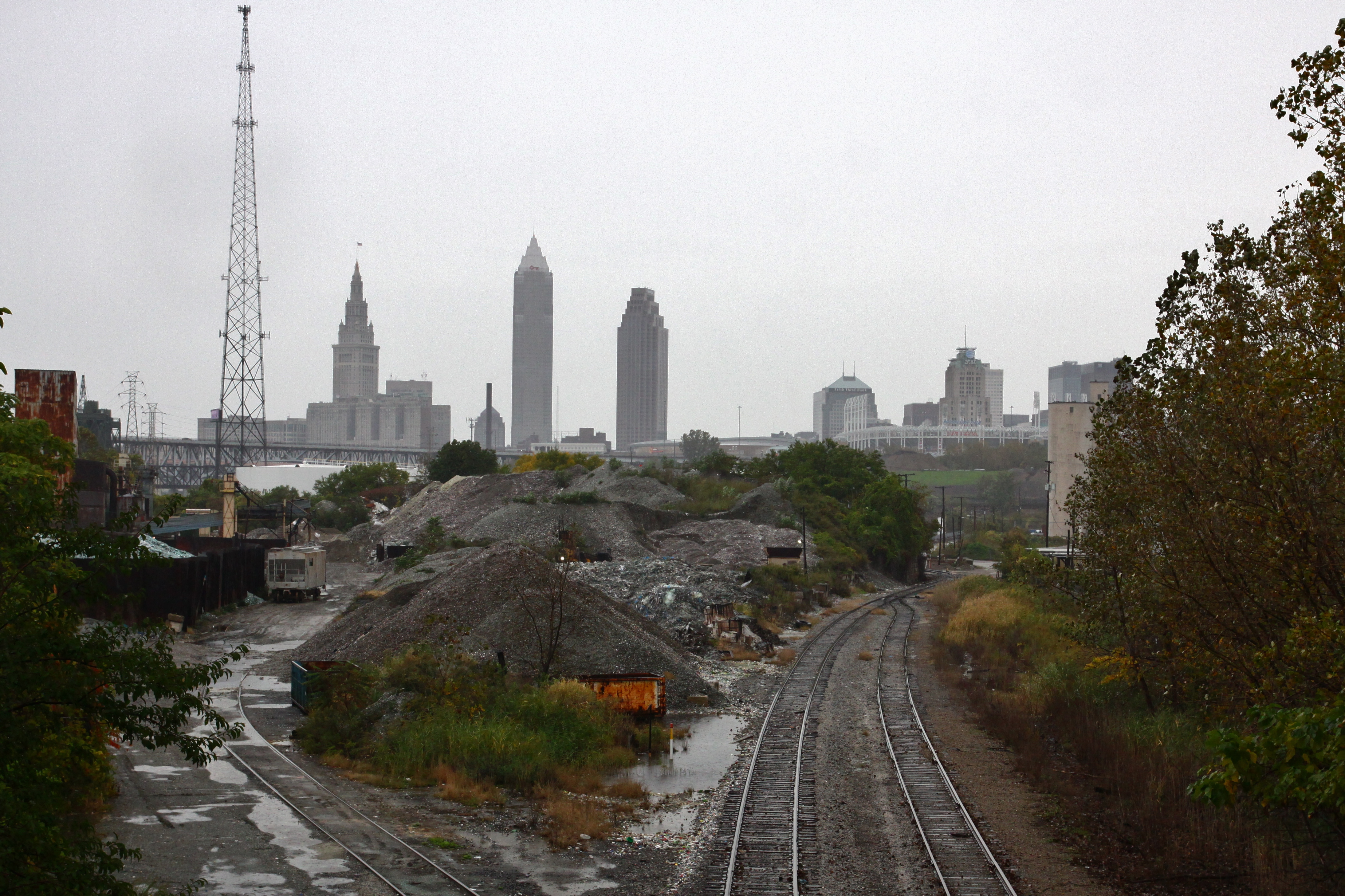 Industrial railway leading to the cloudy city skyline
