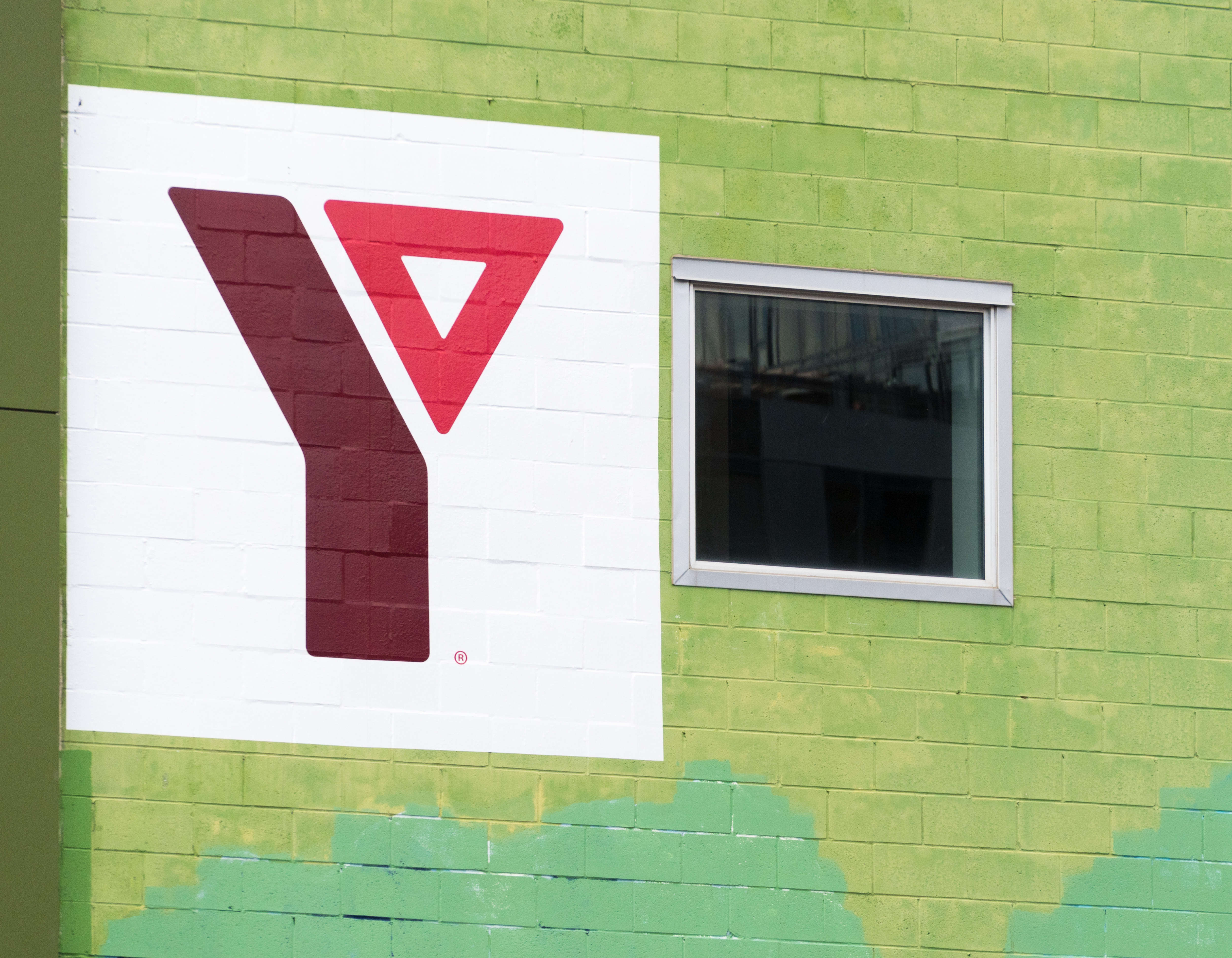 YMCA logo or sign in an old brick wall building. The Young...