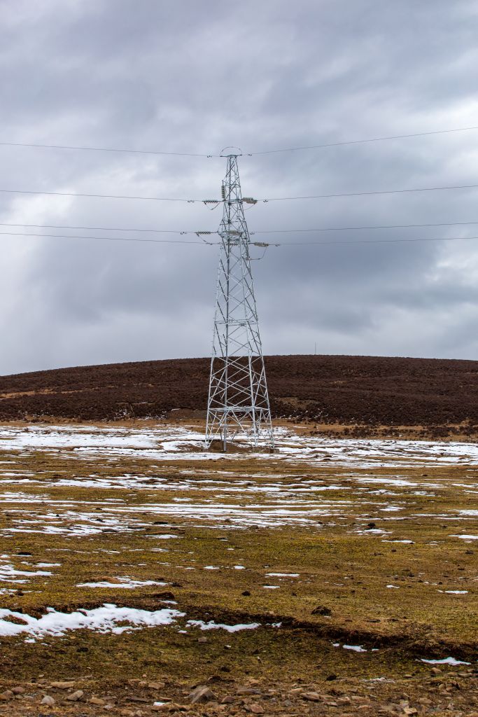 Power line and Beautful snowcapped Mountain