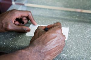 Customer writing cheque in bank