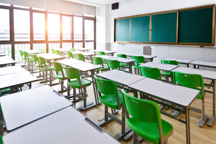 Empty classroom with desks and chairs