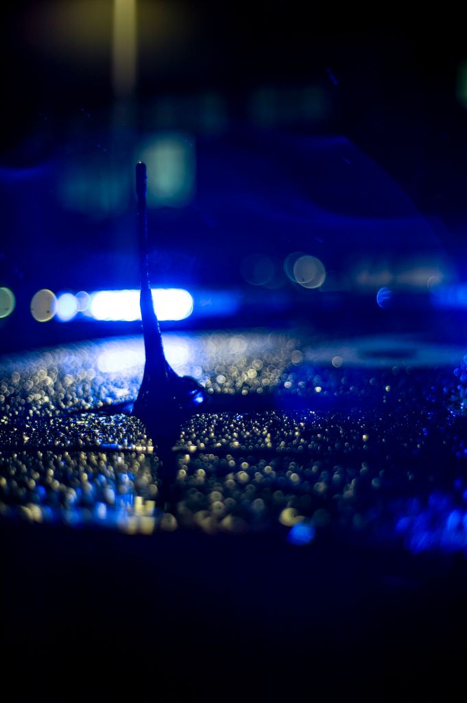Spain, Madrid, rain falling on a police car at night
