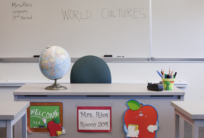 Empty desk of teacher in classroom