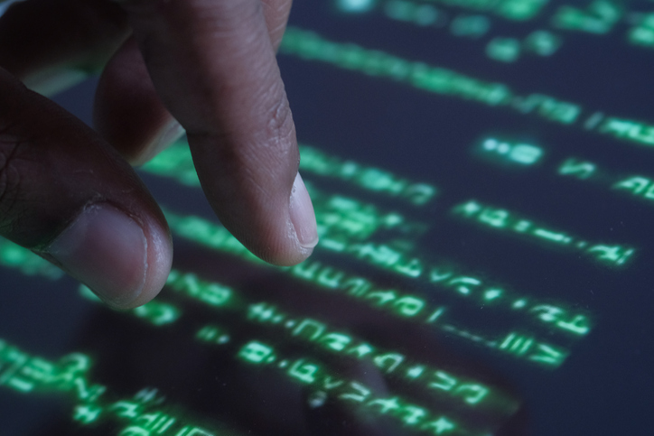 Hacker hand working on iPad