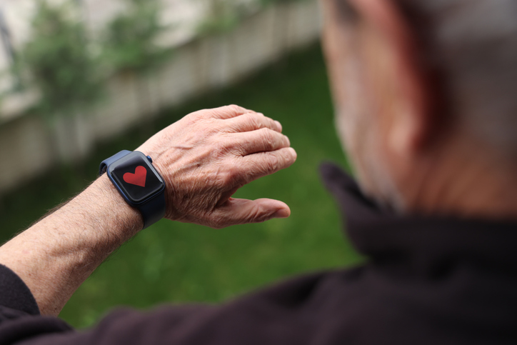 Senior man checking health monitor on smart watch
