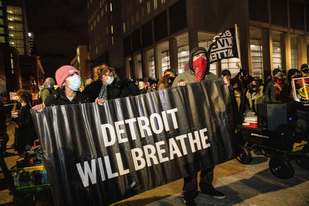 Protesters hold "Detroit Will Breathe" banner during the...