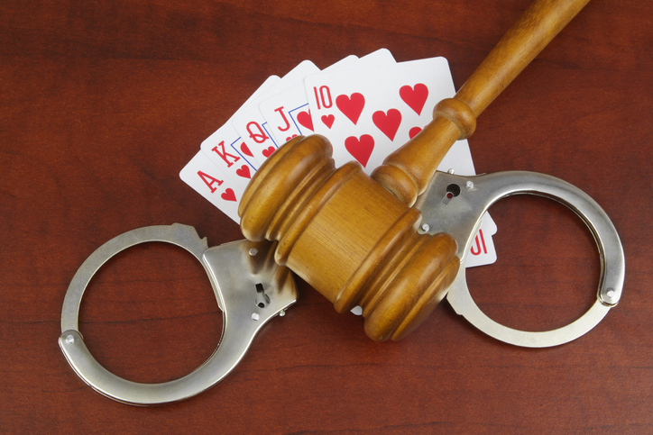 Gambling and law theme, playing cards and gavel with handcuffs