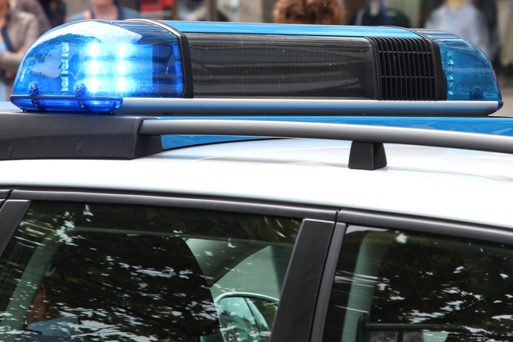 police car with active blue emergency vehicle lighting