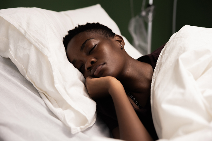 Young African patient peacefully rests in her hospital bed