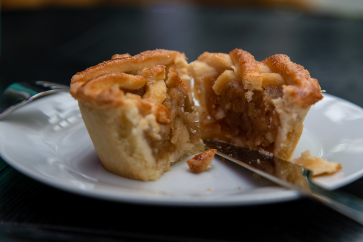 small apple pie cut in half